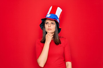 Young beautiful brunette woman wearing united states hat celebrating independence day Touching painful neck, sore throat for flu, clod and infection