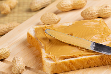 Delicious peanut butter sandwich on a wooden background