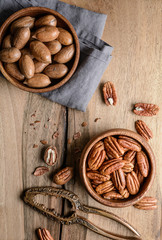 Healthy snack rich in vitamins and minerals, fresh shelled and in-shell pecans in a bowl