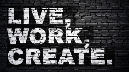 Live, work, create, motivation slogan, white text on black brick wall