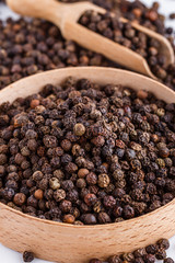 fragrant black pepper on white acrylic background