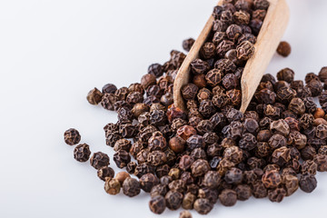 fragrant black pepper on white acrylic background