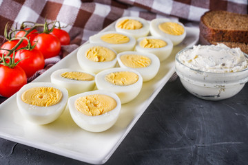 boiled chicken eggs on a dark stone background