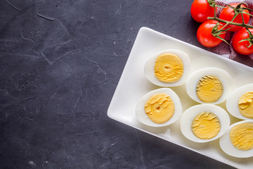 boiled chicken eggs on a dark stone background