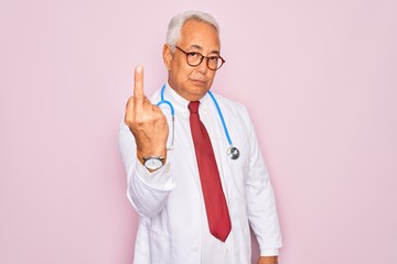 Middle age senior grey-haired doctor man wearing stethoscope and professional medical coat Showing...