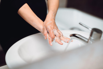 Pregnant Woman washing hands correctly and responsibly during home quarantine