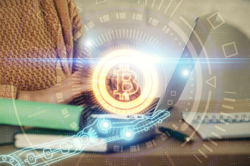 Double exposure of woman hands typing on computer and crypto market theme hologram drawing....