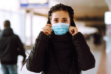 Girl in protective sterile medical mask on her face in quarantine city. Woman, wear face mask,...