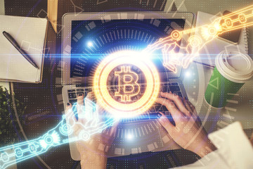 Double exposure of woman hands typing on computer and crypto market theme hologram drawing....