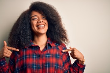 Young beautiful african american woman wearing casual shirt over isolated background looking...