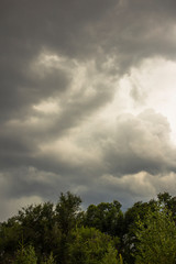  The eerie clouds had invaded the sky. Storm front over the fields. Tragic gloomy sky.