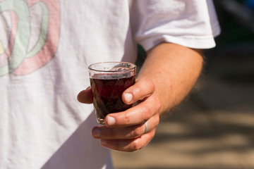 The winemaker is tasting wine. Glass in the hand of a man. Harvest home. Wine-making. Technology of wine production. Wine production in Moldova.