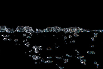 water waves with beautiful bubbles on a black background.