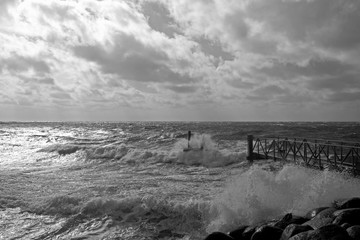 Laesoe / Denmark: Rough surf on the quay wall in Vesteroe Havn in April
