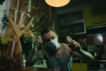 Drinking man with antiseptic and mask