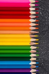 Colored pencils on a black stone table