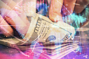 Multi exposure of financial theme drawing hologram and USA dollars bills and man hands. Business...
