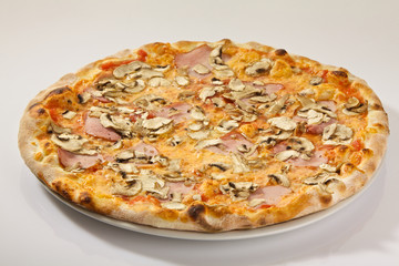 Flatlay of Italian pizza on white background. Rustic homemade pizzas with salami, bacon,  cheese, eggs and raw vegetables on shabby wooden background. Healthy vegetarian fungi pizza