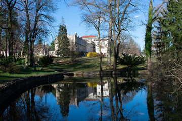 Fototapeta na wymiar The Elkins Estate From Over a Pond Reflecting Off of It