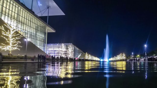 Athens, Greece - December 15, 2019: Night view of colourful dancing water fountain event at Stavros Niarchos Foundation Cultural Center (SNFCC) in Athens. Christmas decorations. Time Lapse. FullHD
