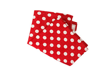 Red cotton napkin with polka dot pattern. Folded napkin isolated on white background. Top view.