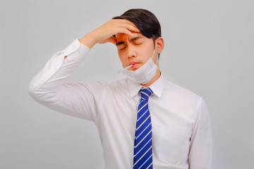 Businessman wears medical masks with fever checking her temperature is a viral disease contagious feel pain in their nose on head background, corona virus concept, covid19 concept, medical concept