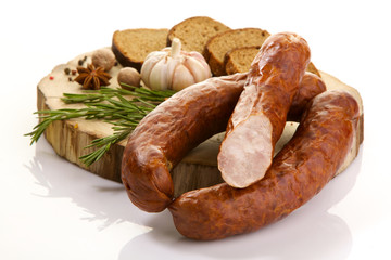 Easter sausage isolated on white background. Beef on wooden background