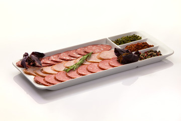 Assortment of cold meats and sausage isolated on white background