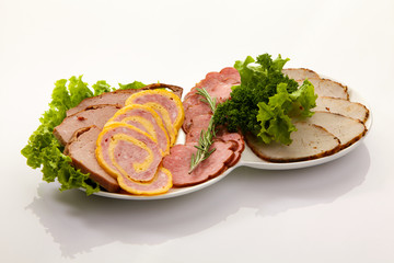 Assortment of cold meats and sausage isolated on white background