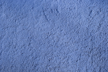 Decorative classic blue stucco on the wall, texture. Textured blue background. Classic blue wall texture