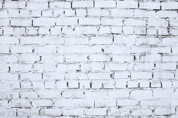 Old weathered aged brick wall colored in white. White brick wall background