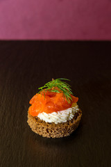 tasty canapes with seafood on a red background. Vertical frame