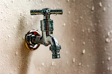 Fototapeta na wymiar faucet metal silver wet drops drinking system copy space