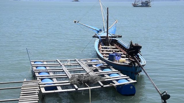 Floated piers and boat in blue sea