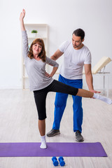 Young woman doing sport exercises with personal coach