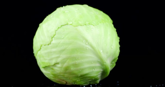 A forks fresh cabbage slowly rotates.