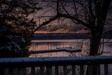 View of the snow-covered pier during early morning twilight at Lake Johnson Park in Raleigh, North Carolina.