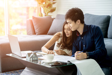 Young Asian Adult Couple Planning New Home Design.