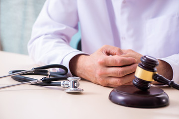 Male doctor in courthouse meeting with lawyer