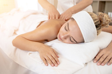 Fototapeta na wymiar Woman Relaxes in the Spa Body massage Treatment.