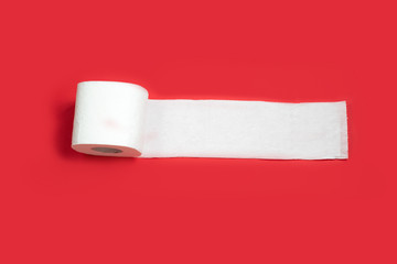 Toilet paper roll on red background. Copy space.