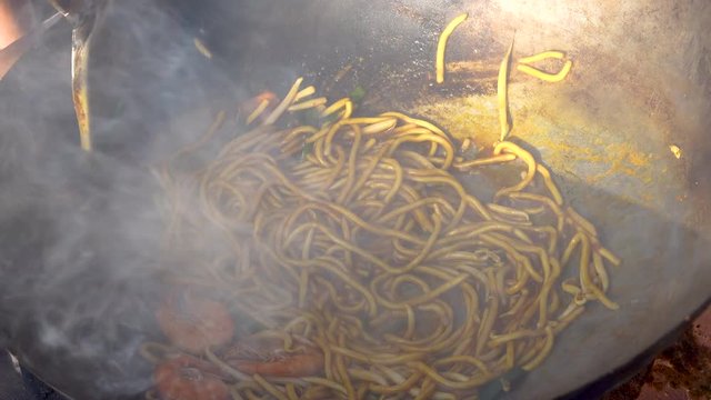 4K realtime footage the making of Mie goreng, also known as bakmi goreng or fried noodle dish, popular in Malaysia, Indonesia Brunei Darussalam, and Singapore.
