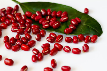 Red beans with a leaf on white background
