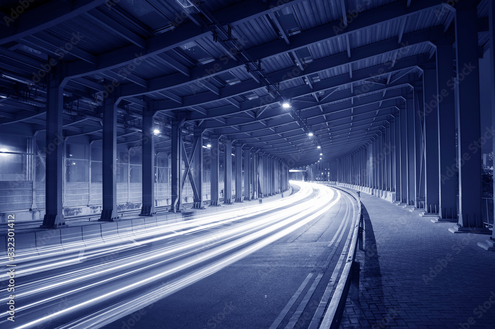 Poster light trails and head lights of traffic in tunnel