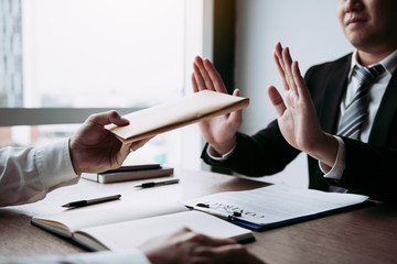 Businessmen are holding cash envelopes in order to bribe with the investment project participants corruption concept.
