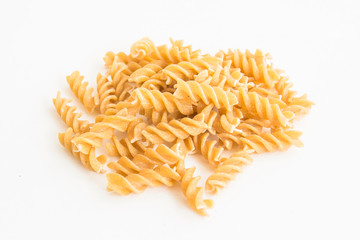 A raw macaroni on the white isolated background