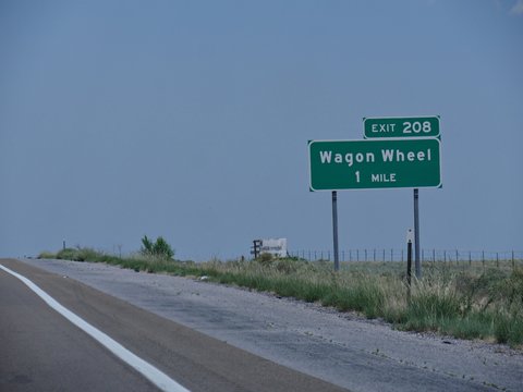 Directional signs on the highway with directions to Wagon Wheel exit in New Mexico.