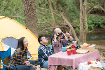 happy family has father and mother, brother and sister asian having fun to camping in river in summer time with smile and laughing healthy. summer camp for kids. vacation lifestyle concept.