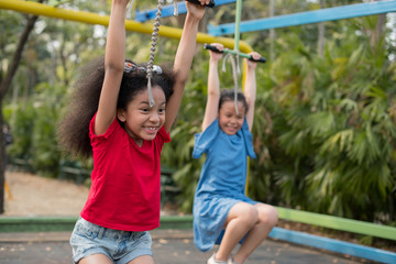 Fototapeta na wymiar happy multi-ethnic children having fun to playing in the playground in summer time with smile and laughing healthy, funny smiling face adorable lovely female kid. happy vacation lifestyle concept.