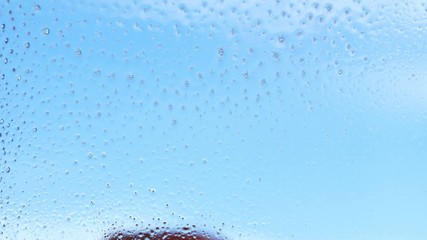 Female hand cleaning window with rag and spray soap. Housework concept